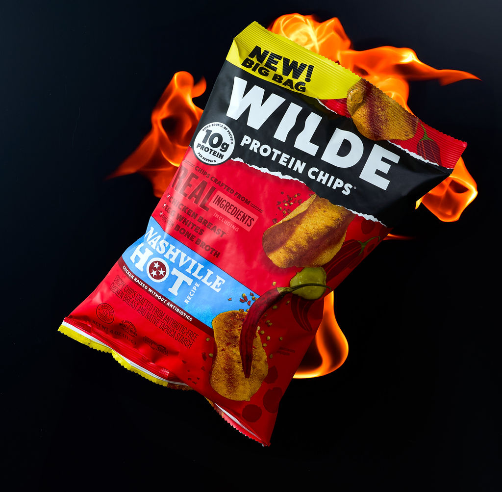 Wilde Nashville Hot protein chips bag photographed with real flames on black