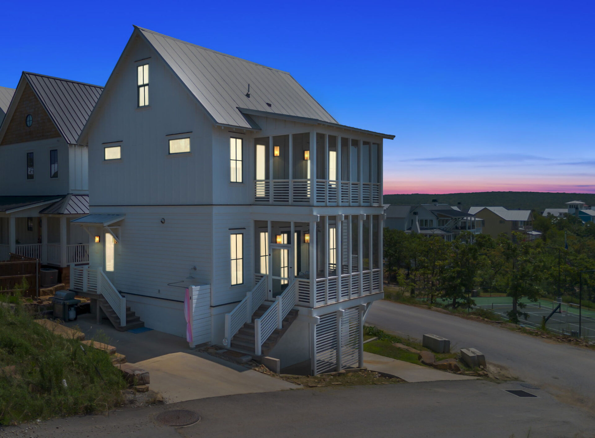 Lake house exterior photographed at true twilight in Northeast Oklahoma