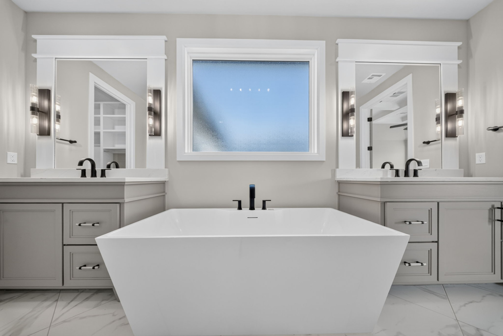 Primary bathroom with freestanding soaking tub and twin vanities in a Broken Arrow Oklahoma new construction home