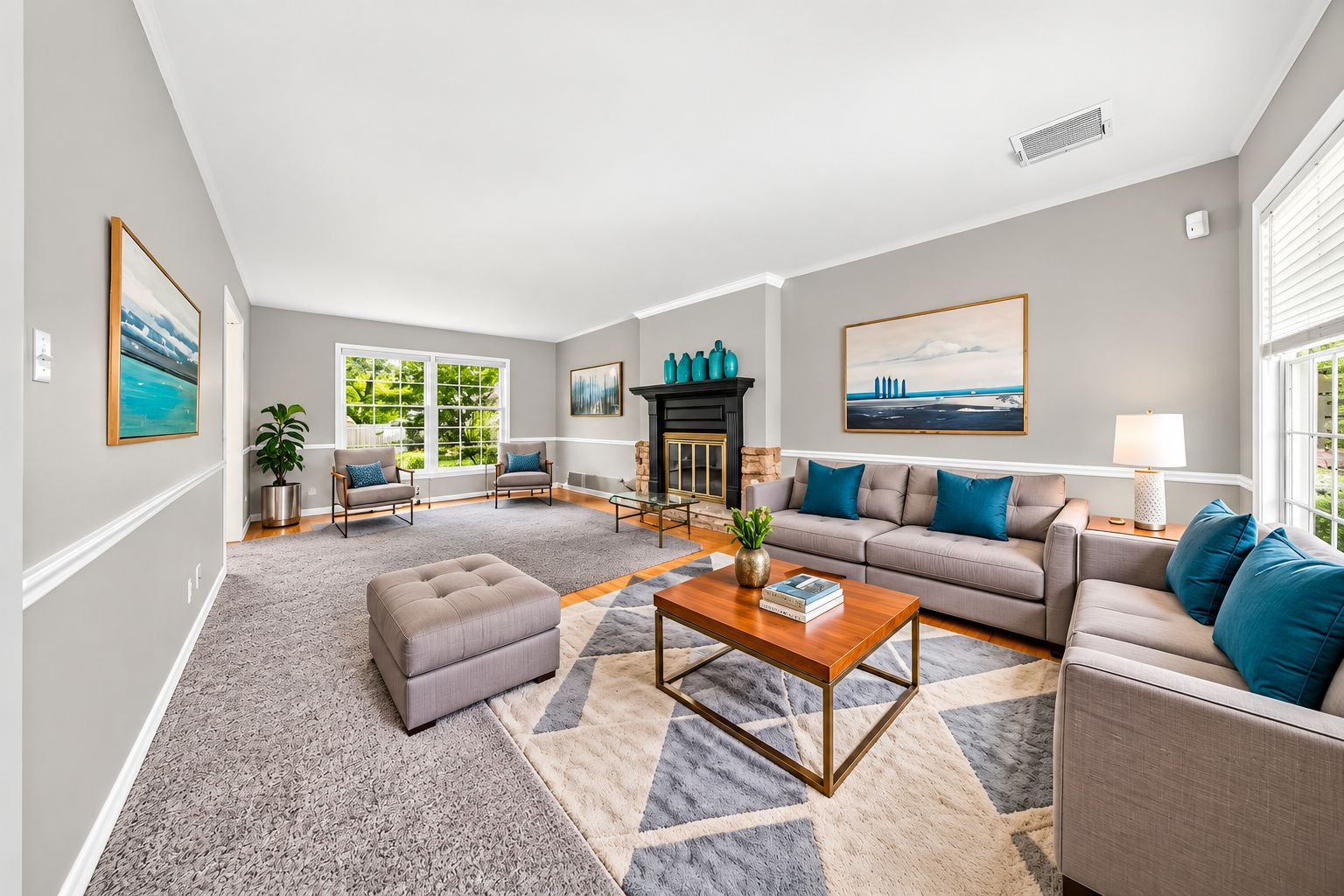 Bright staged living room with fireplace and teal accents