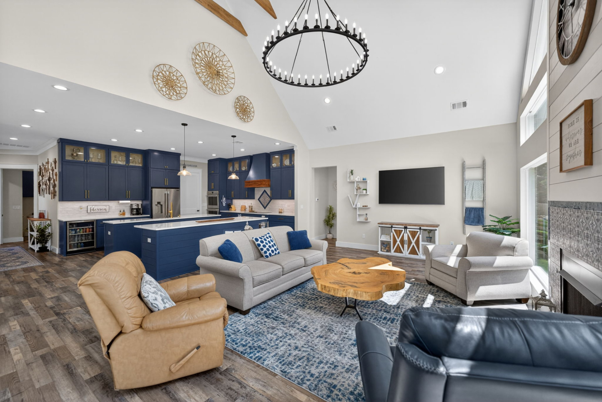 Vaulted living room open to a navy kitchen, photographed by Killer Visuals in Owasso Oklahoma