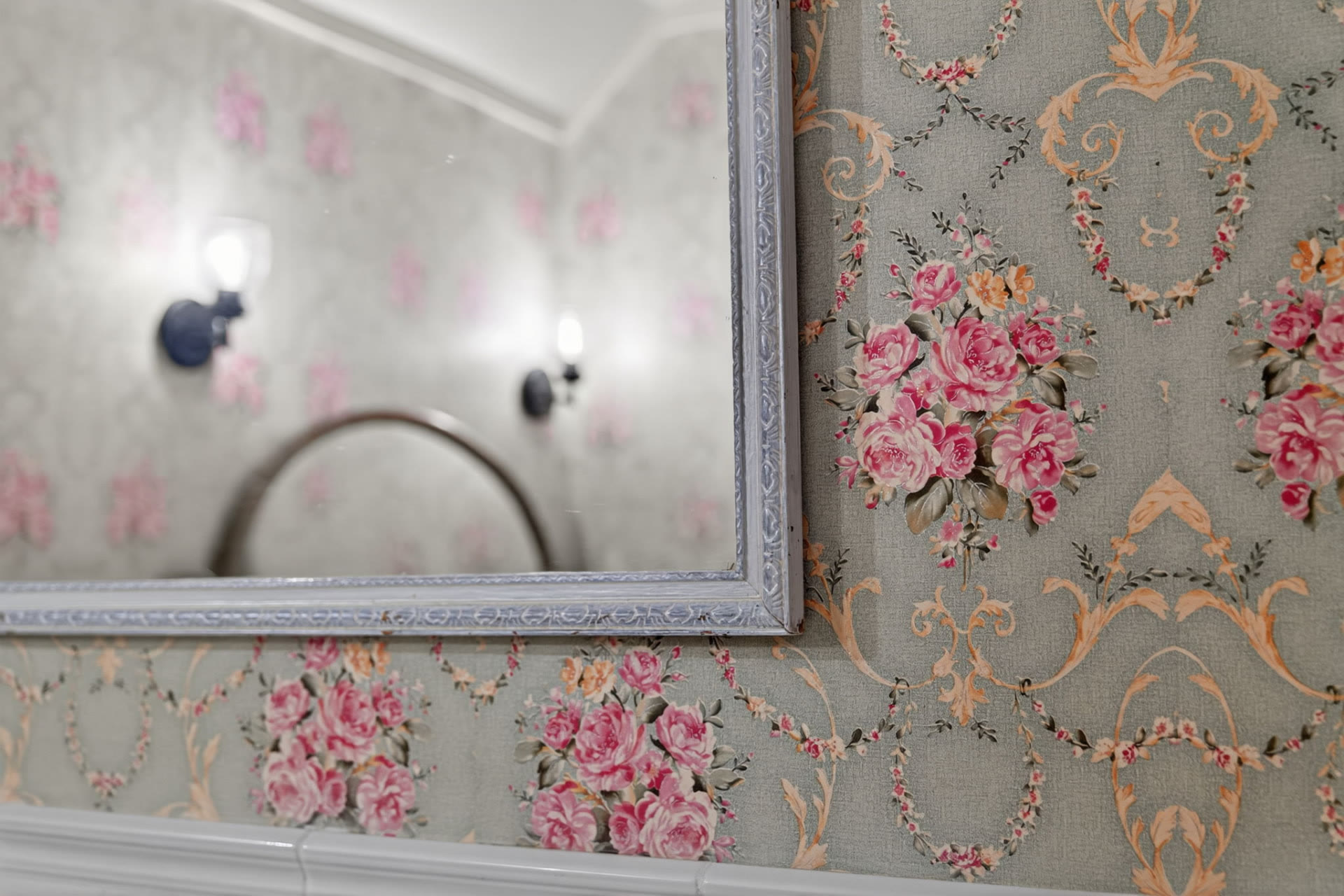 Floral wallpaper and mirror detail in a Midtown Tulsa home