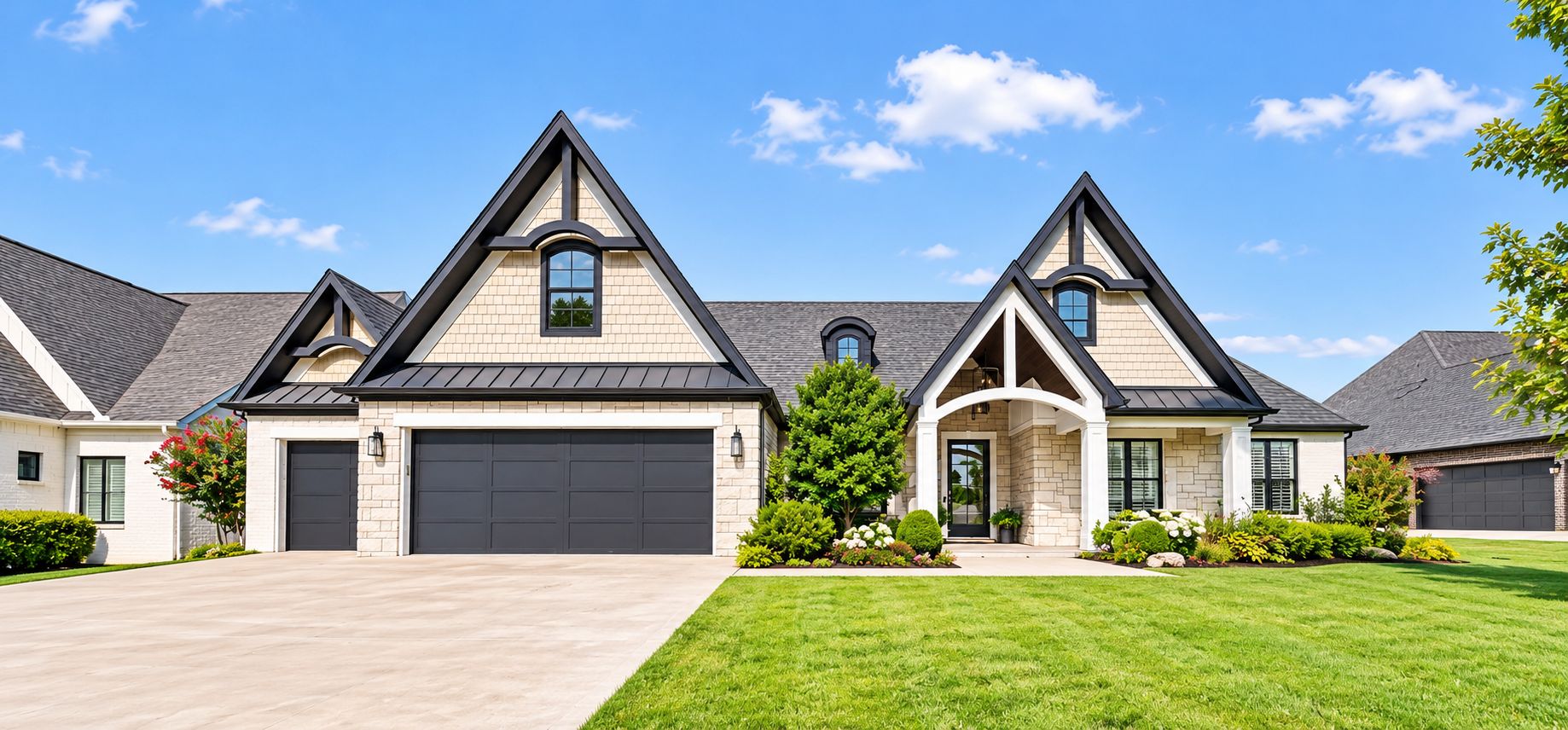 Luxury stone home with landscaped front lawn under a blue sky — Owasso, OK
